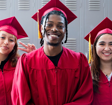 three students at graduation